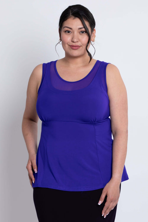 Front close-up of plus size model wearing a vibrant purple mesh detail tank top