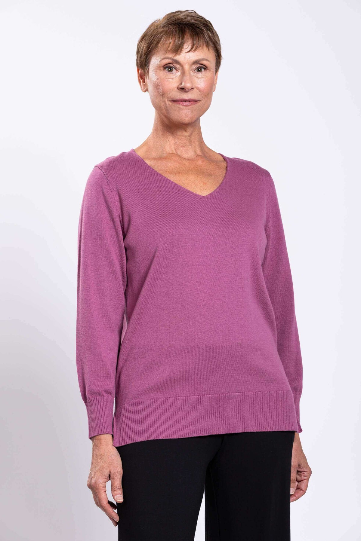 Front close-up of woman wearing a mauve V-neck cotton sweater