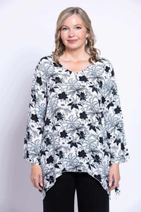 Front view closeup of woman in Dorothy black floral bohemian flowy top with v-neck and bell sleeves