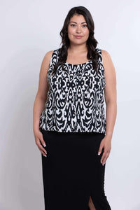 Front facing view of model wearing sleeveless Ikat print tank and black skirt