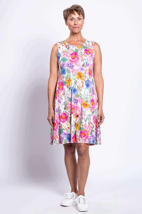 Front view of woman modeling colorful sleeveless floral dress