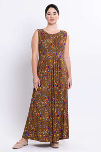 Woman wearing a brown sleeveless maxi dress with colorful floral print, full length front view