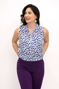 Front half-tucked look of blue dot print sleeveless tank on woman