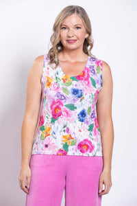 Front view of woman wearing a vibrant floral cotton tank top with pink pants