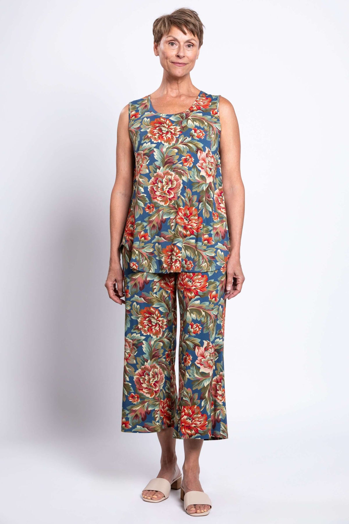 Older woman standing in matching floral tank and wide leg pants