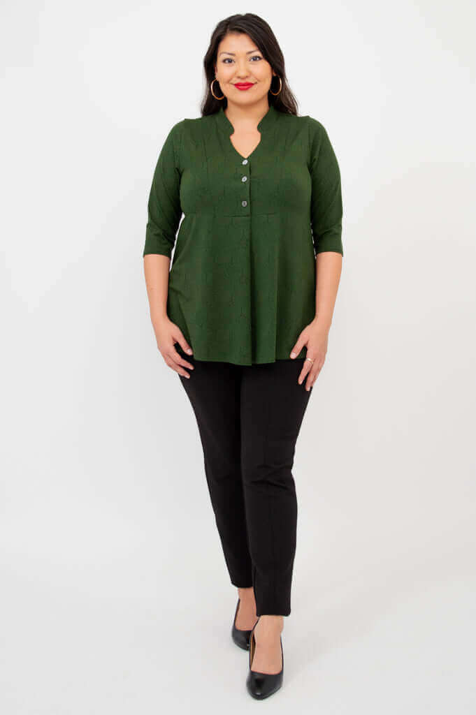 Front view of woman modeling green V-neck bamboo top and black pants