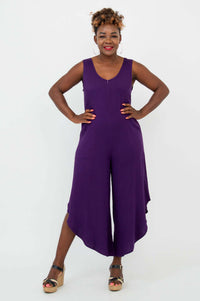 Model posing front-facing in purple asymmetrical jumpsuit
