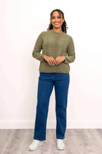 Woman modeling a dark olive green long sleeve button down sweater styled with classic blue jeans.