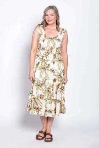 Woman posing in cream tropical midi dress with wide straps, front view