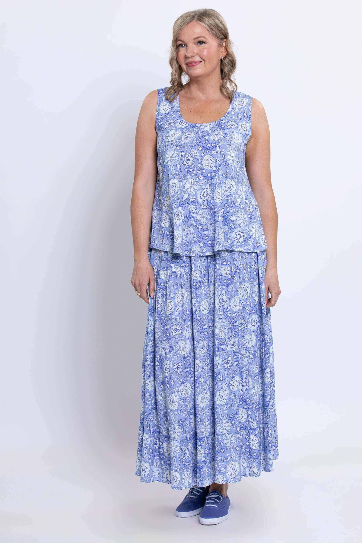 Woman standing in Ginny Tank and blue floral skirt, front view