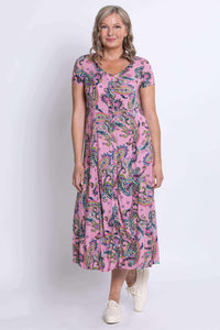 Front standing pose of woman in pink paisley midi dress