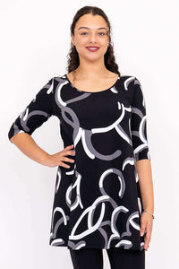 Front view of model wearing black A-line dress with white and gray abstract print