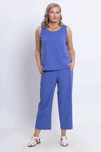 Front view of model wearing blue cropped pants with sleeveless top