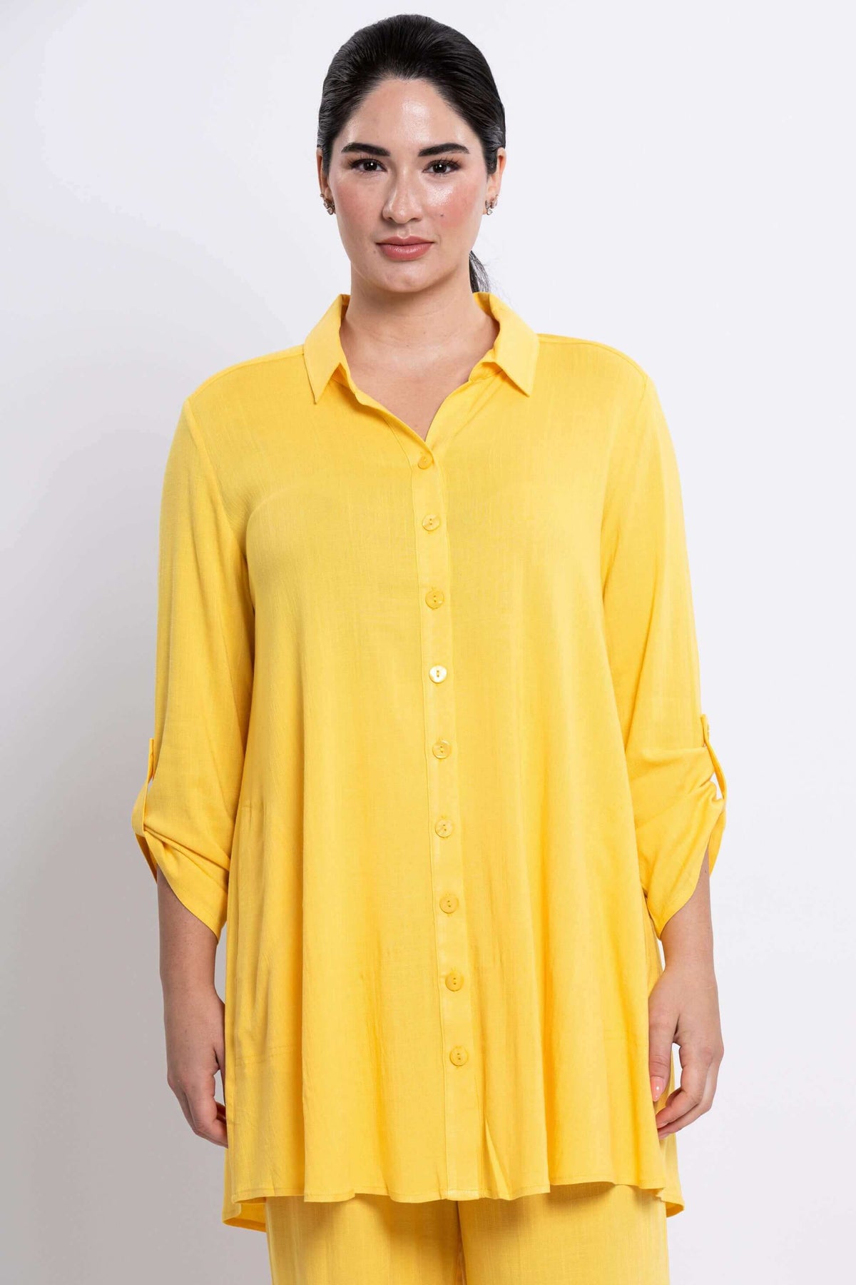 Front view of model wearing a sunflower yellow button-up bamboo-linen tunic with 3/4 sleeves
