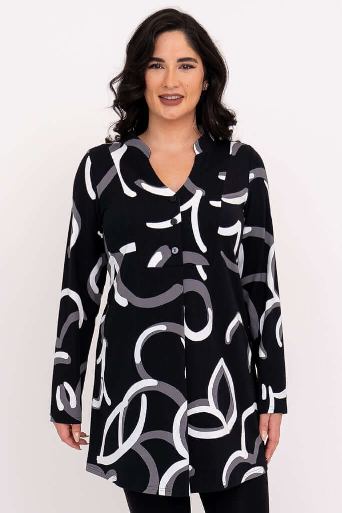 Front view of woman wearing black tunic with white and grey abstract print.