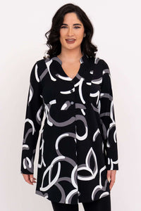 Front view of woman wearing black tunic with white and grey abstract print.