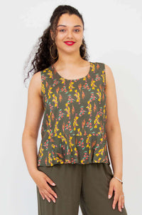 Front view of model wearing Ginny Floral Peplum Tank in olive green with yellow and red print