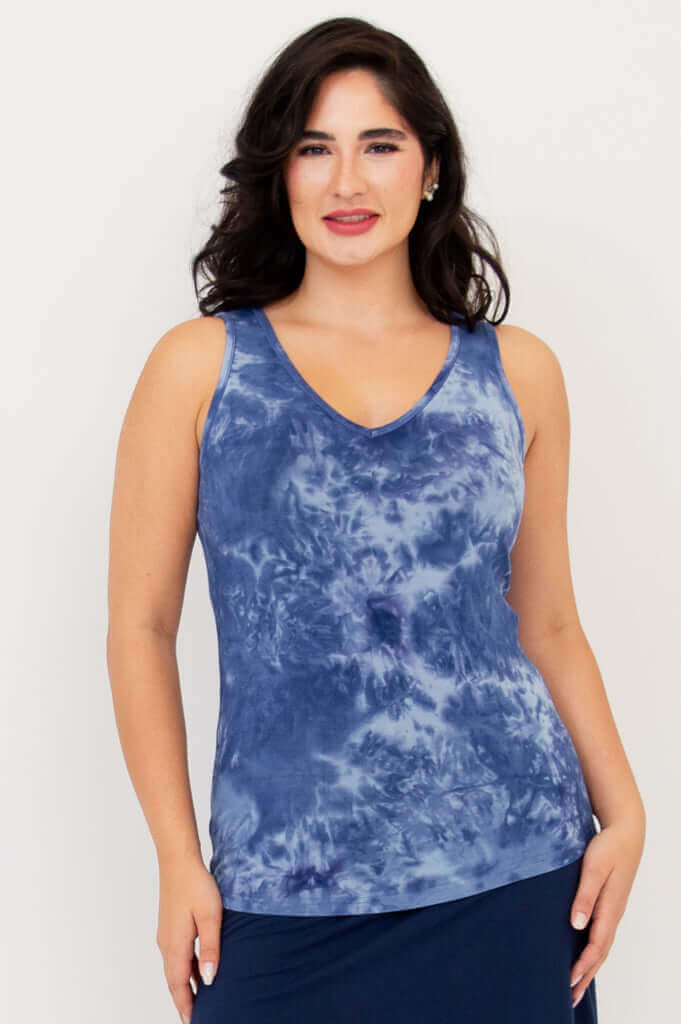 Front view of model wearing indigo tie dye reversible bamboo tank with V-neck