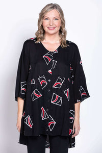Front view of a woman wearing a black tunic blouse with abstract red and white patterns