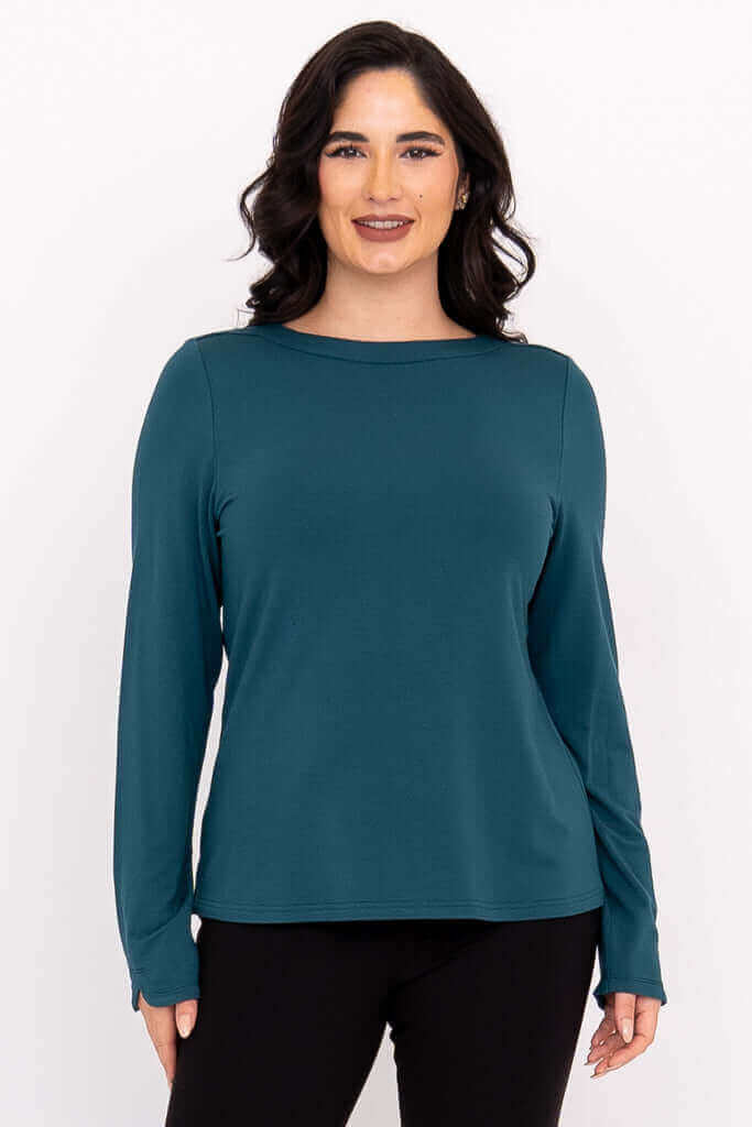 Front view of woman wearing teal Mona boat neck top with long sleeves