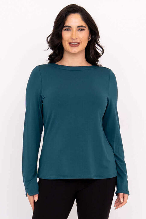 Front view of woman wearing teal Mona boat neck top with long sleeves