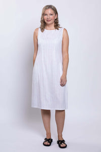 Front view of a woman wearing a sleeveless white midi dress with thin vertical stripes