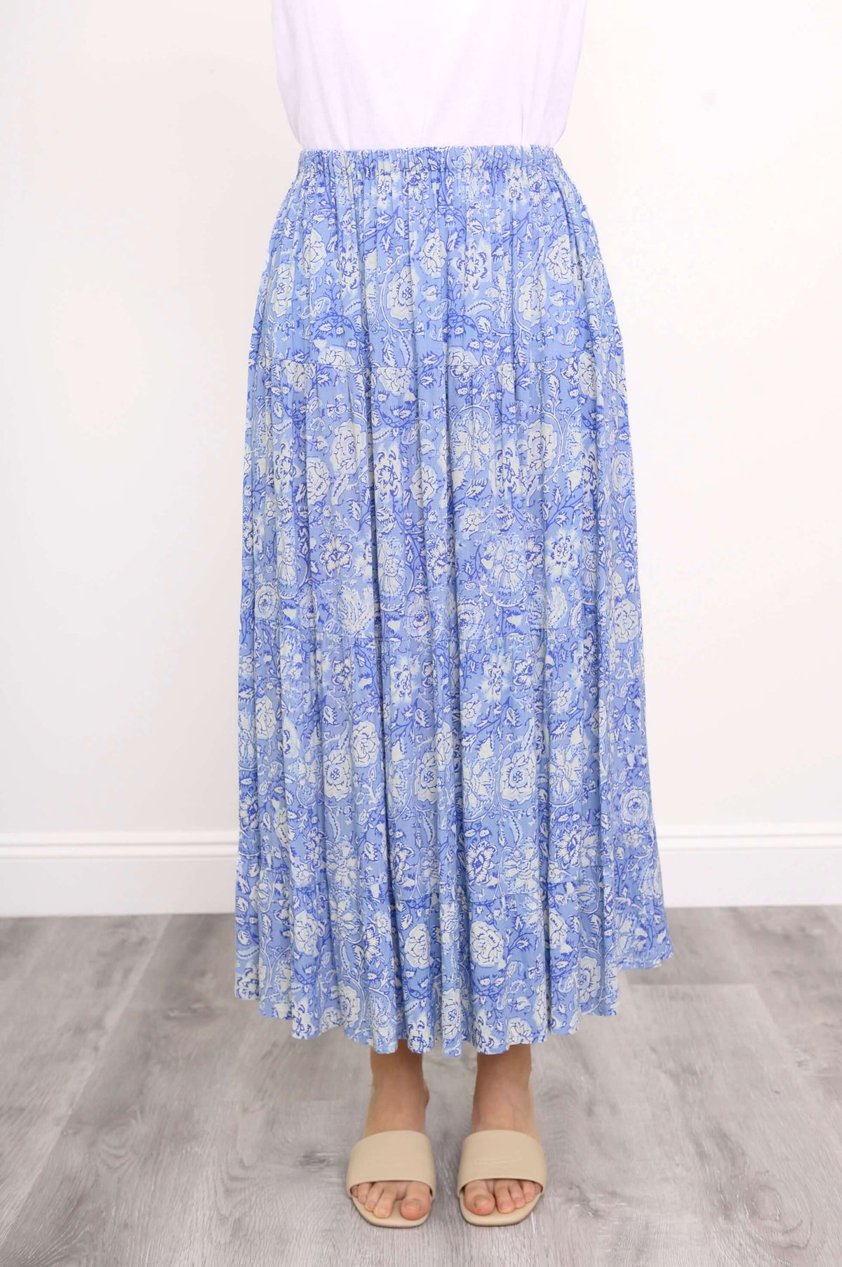 Front view of the Roma blue floral tiered skirt with elastic waistband