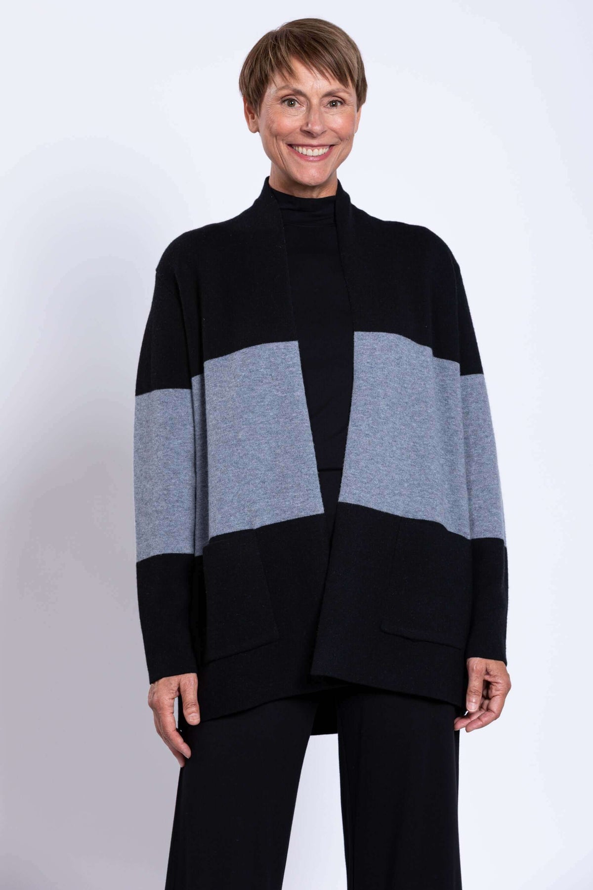 Front view of woman modeling Seltic Sweater with patch pockets, hands relaxed