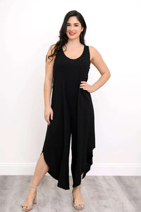 Front view of model in black sleeveless jumpsuit with relaxed fit