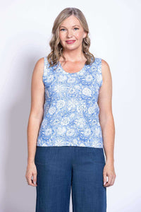 Front view of woman wearing a blue floral sleeveless tank top and blue pants