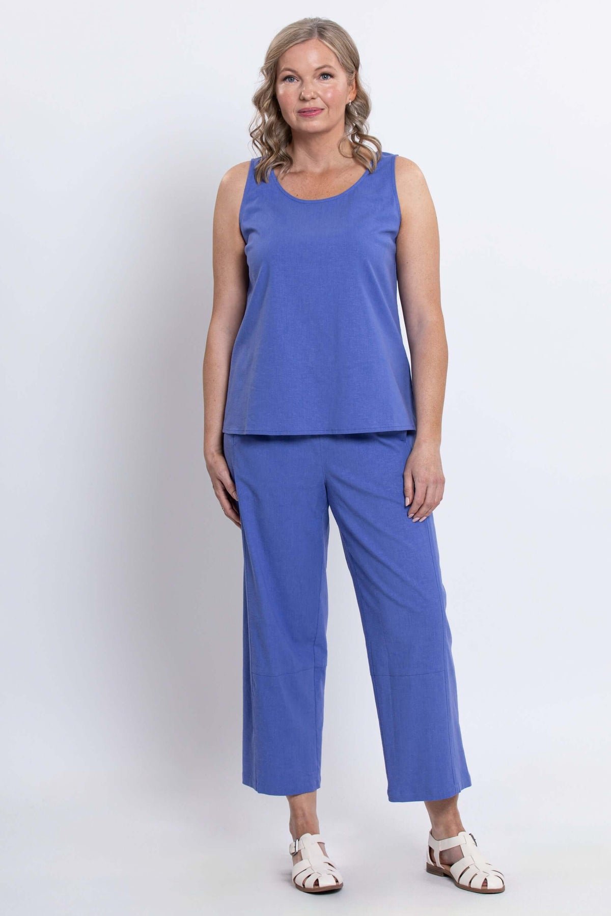 Front view of woman in blue sleeveless tank and pants set