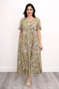 Front view of a woman in a green floral empire waist maxi dress