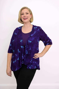 Woman smiling, hand on hip, in purple Toucan Jacket with blue dragonflies front view