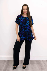 Model in black and blue floral curved-hem tunic and black pants front view