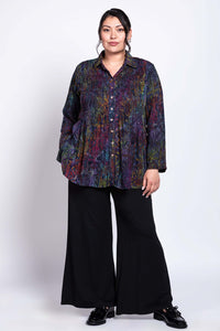 Full body front view of model wearing Cindy shirt, hands in pockets, paired with black pants