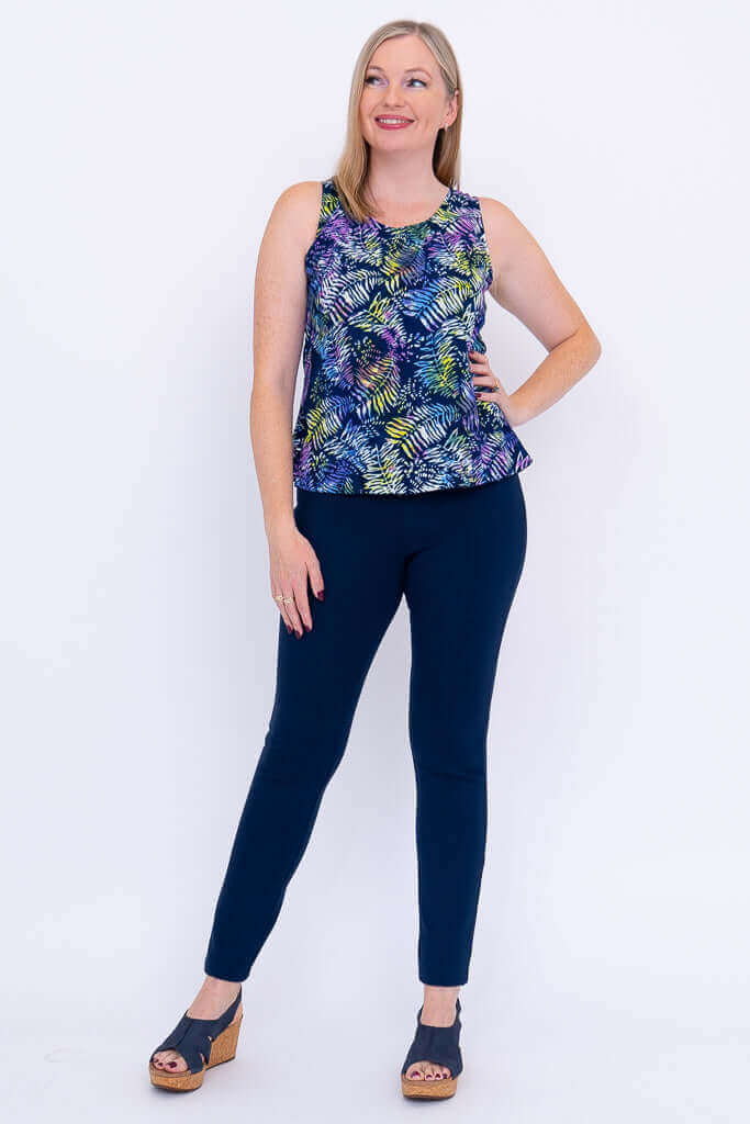 Woman modeling sleeveless Dee Tank with multicolored leafy pattern, front view