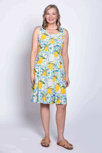 Front view of model wearing sleeveless lemon tile print dress with scoop neckline