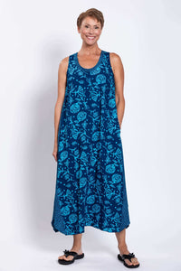 Front view of woman wearing blue floral Ari tank dress with scoop neckline