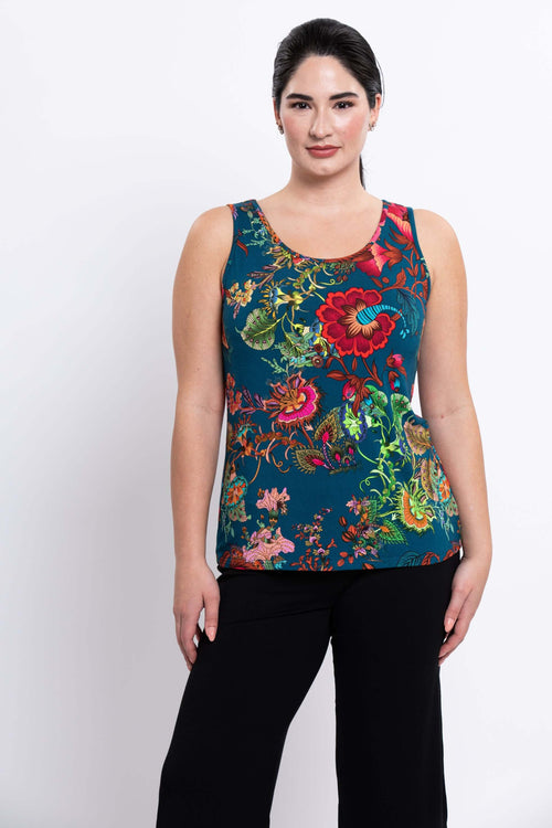 Front view of woman wearing a teal tank top with vibrant multicolor floral print