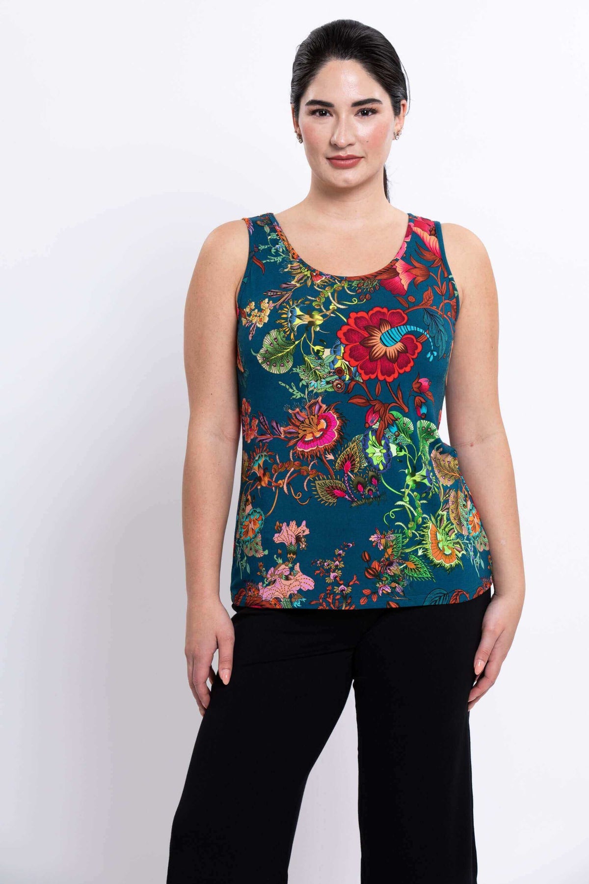 Front view of a woman wearing a sleeveless teal floral Avalon bamboo tank top