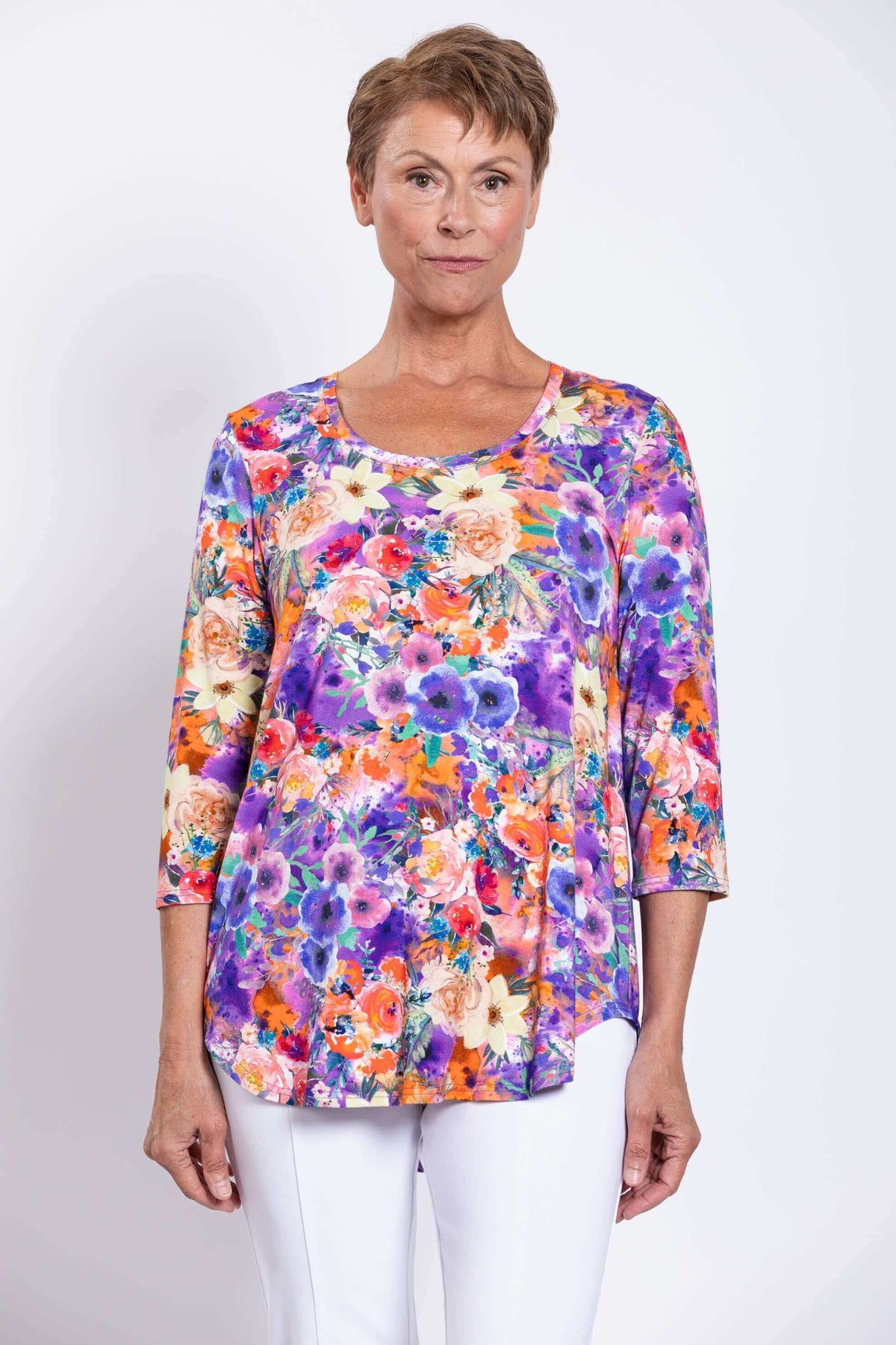 Front view of a woman wearing a colorful floral bamboo top with 3/4 sleeves