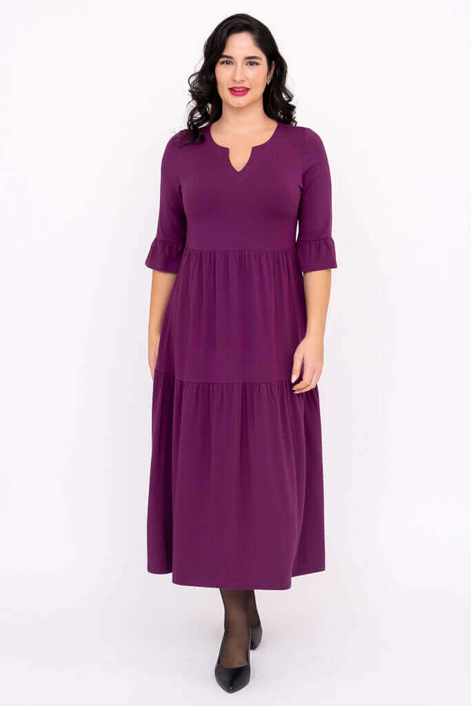 Front view of the Bernadette Long Dress in purple with keyhole neckline and ruffled cuffs