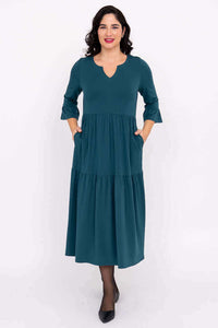 Front view of model in teal Bernadette Long Dress with pockets