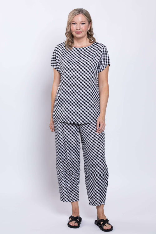 Model showcasing black and white gingham cropped pants and top from the front