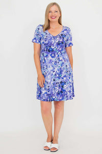 Front view of woman wearing a violet floral ruched V-neck dress