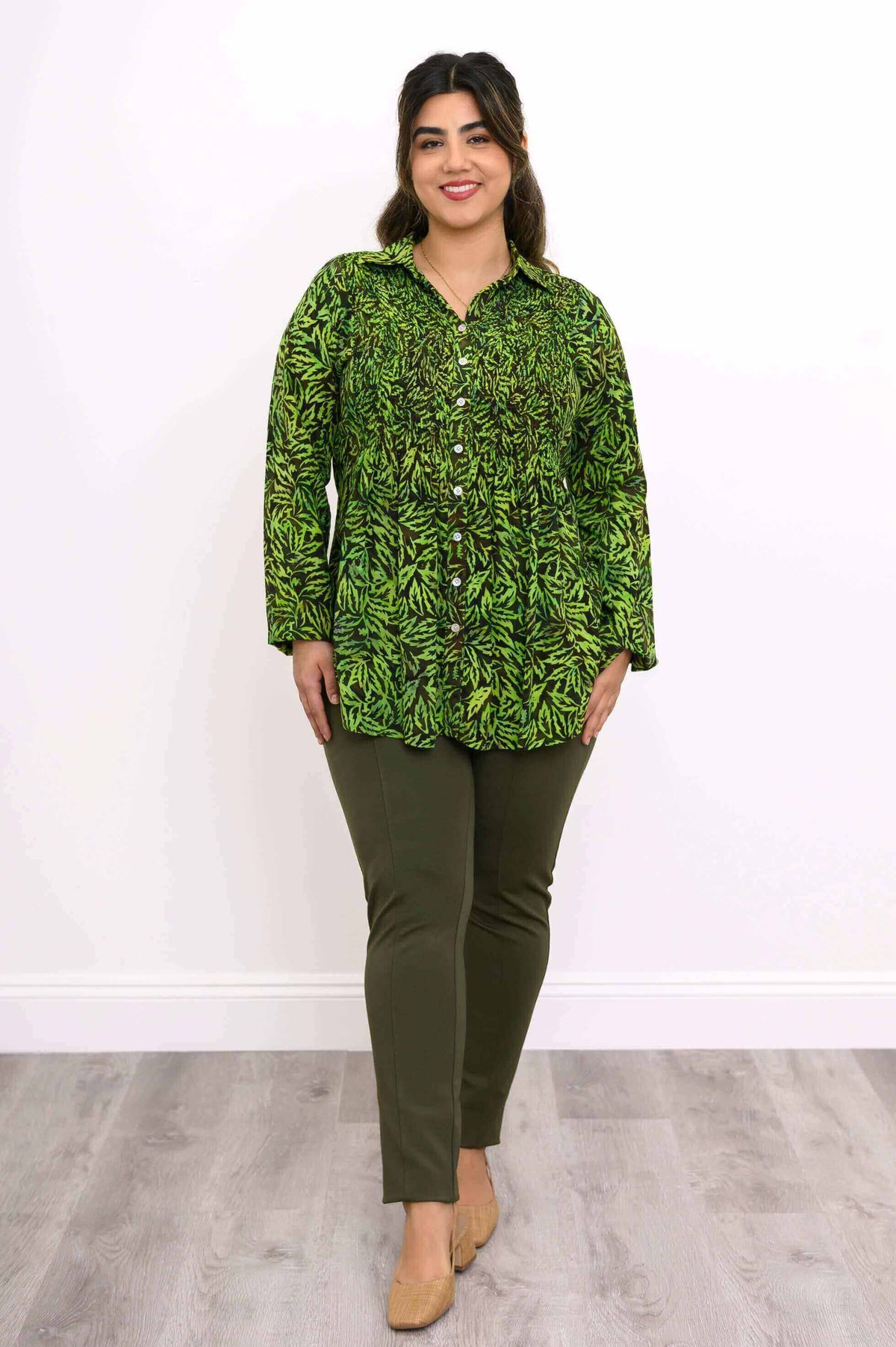 Woman modeling the Cindy green leaf smocked top with olive pants, front view