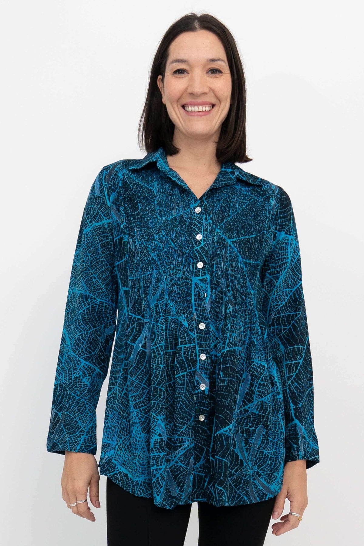 Front view of model wearing blue leaf-patterned Cindy long sleeve button-up shirt