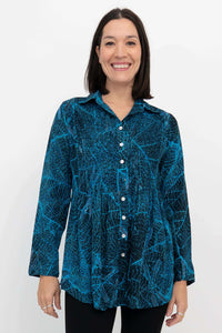 Front view of model wearing blue leaf-patterned Cindy long sleeve button-up shirt