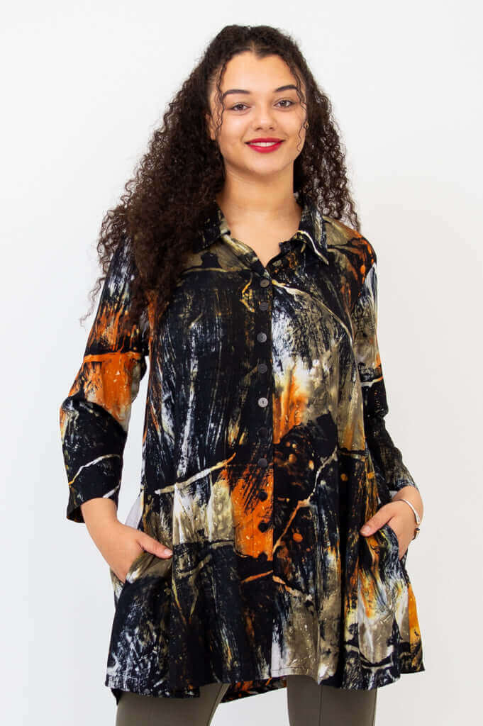 Front view of Cissy Long Sleeve Top in abstract orange and black print