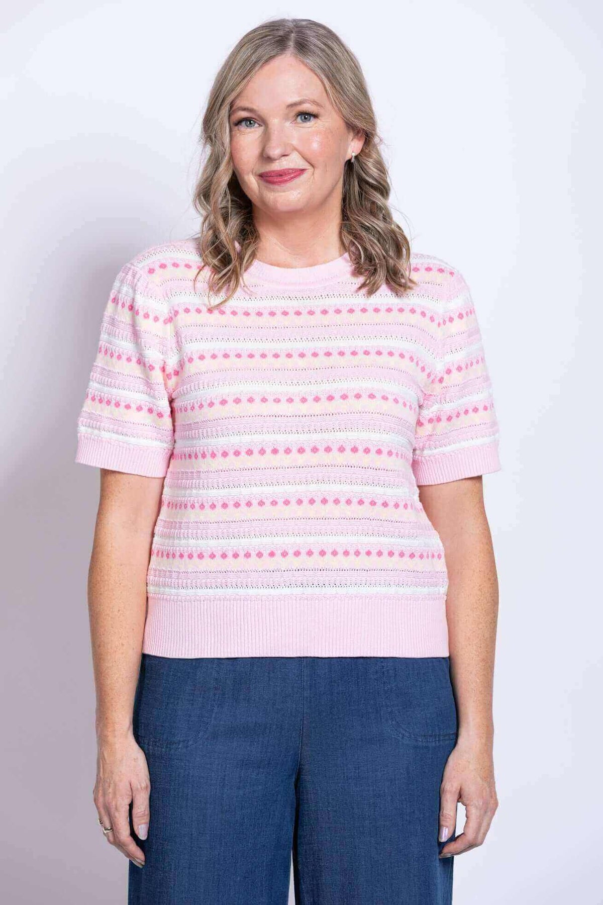 Front view of woman wearing Danny Sweater in light pink with dot stripes